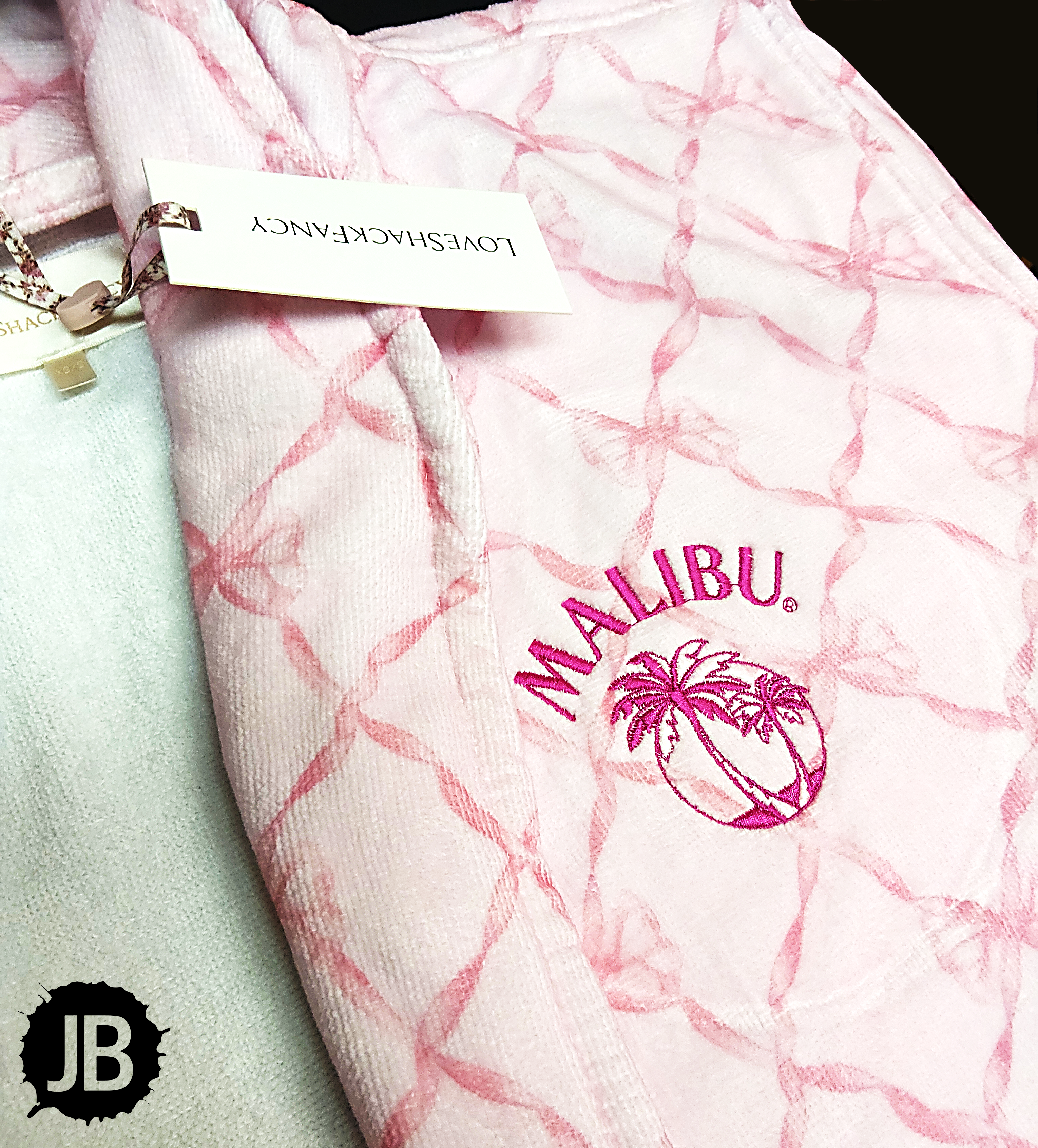Pink robe embroidered with a Malibu logo in magenta thread